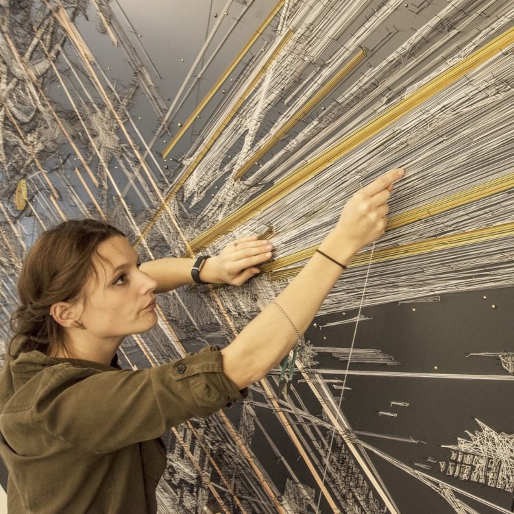 Debbie Smyth installing Fleeting at 10 Fleet Place, London, 2019. 2.5m x 10m (8' 2” x 32' 9”). Pins and thread. Photography: Zac Mead